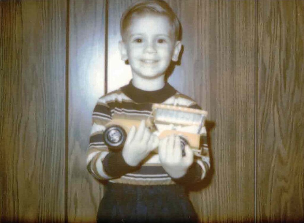 A young boy holding a train