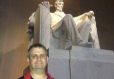 A man standing in front of the lincoln memorial.